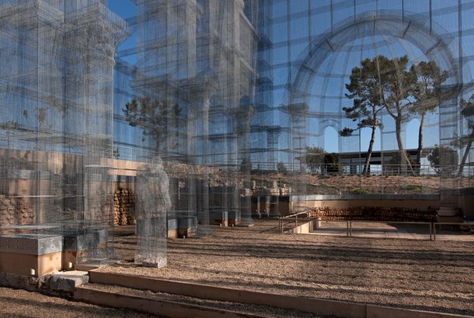 The ghostly structure also features metal wire versions of sculptures that stood within the original church. 