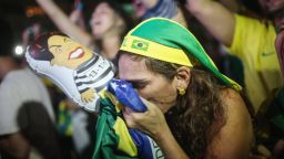 RIO DE JANEIRO, BRAZIL - APRIL 17: A pro-impeachment supporter kisses a Brazilian flag, while a live television broadcast, moments after lower house deputies voted to approve the motion to continue the impeachment process of President Dilma Rousseff on April 17, 2016 in Rio de Janeiro, Brazil. Rio will host the Rio 2016 Olympic Games in August. (Photo by Mario Tama/Getty Images)