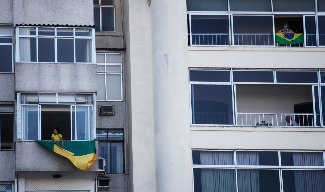 Brazilian flags hang from apartments during demonstrations on the day of voting.