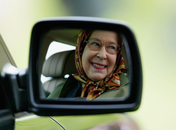 The Queen has often been pictured behind the wheel of Land Rovers, particularly on her estates. In one <a href="index.php?page=&url=http%3A%2F%2Fwww.buzzfeed.com%2Fpatricksmith%2Fim-the-queen-mate-im-driving%23.asmmbgQ87k" target="_blank" target="_blank">famous anecdote</a> which reemerged after the death of Saudi King Abdullah, Her Majesty was said to have driven the then-prince around her Balmoral estate in 1998. Not used to a woman behind the wheel and concerned with her speed, through an interpreter Prince Abdullah "implored the Queen to slow down and concentrate on the road ahead" according to former Ambassador Sherard Cowper-Coles.<br /><br />Here, Queen Elizabeth II is seen reflected in the wing mirror of her Land Rover.