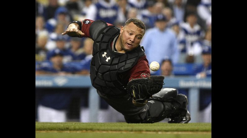 Arizona Diamondbacks catcher Welington Castillo dives to make a catch hit by the Los Angeles Dodgers' Yasmani Grandal during the eighth inning in Los Angeles on Wednesday, April 13.