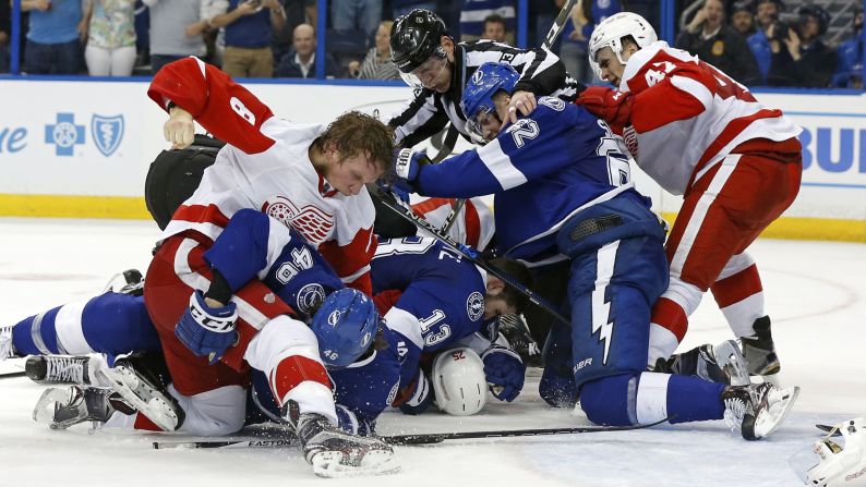 Detroit Red Wings and Tampa Bay Lightning players fight during the third  period in Game Two of the 2016 NHL Stanley Cup Playoffs at Amalie Arena in Tampa, Florida, on April 15. The Lightning defeated the Red Wings 5-2.