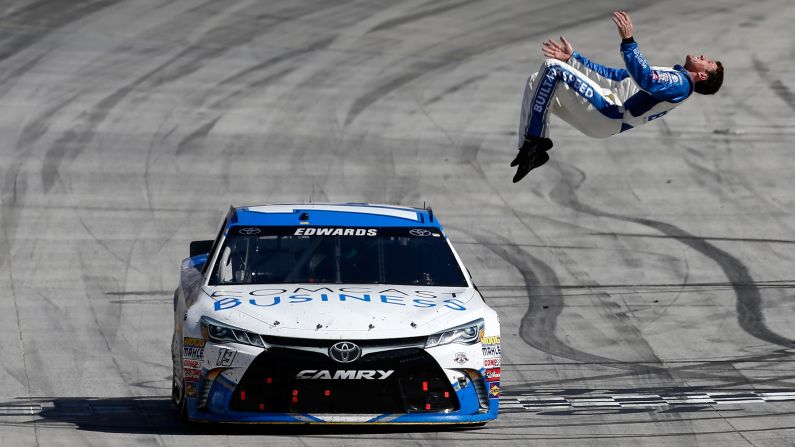 Carl Edwards, driver of the No. 19 Comcast Business Toyota, does a backflip from his car after winning the NASCAR Sprint Cup Series Food City 500 at Bristol Motor Speedway in Tennessee on April 17.