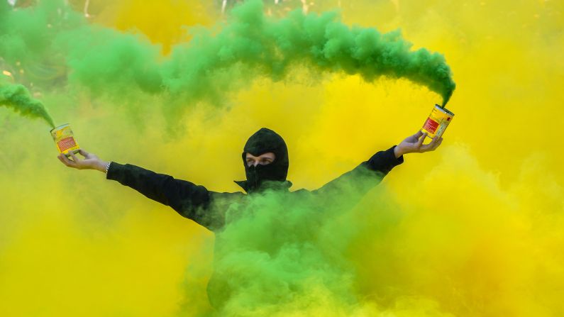 A fan of Nantes holds smoke flares during the French Ligue 1 between Nantes and Montpellier at Stade de la Beaujoire on April 17.