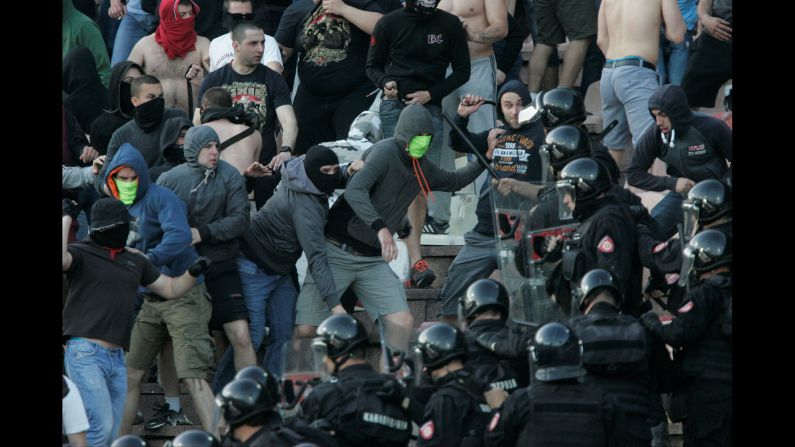 Police intervene after fans on both sides began throwing chairs at one another during the Serbian Super League play off match between Red Star Belgrade and FK Partizan in Belgrade on April 16.