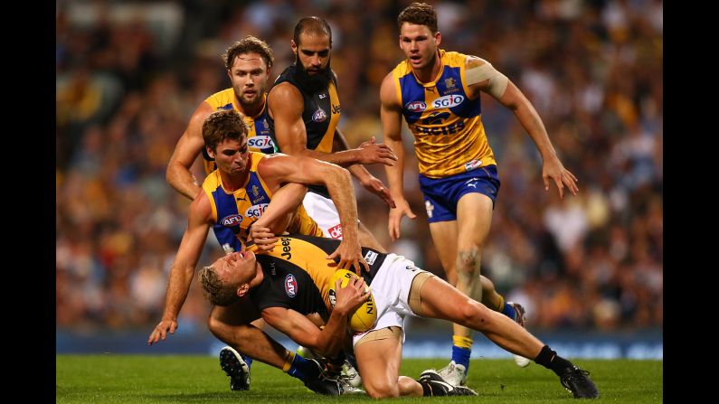 Taylor Hunt of the Richmond Tigers gets tackled by Jamie Cripps of the West Coast Eagles during the round four AFL match at Domain Stadium in Perth, Australia, on April 15.