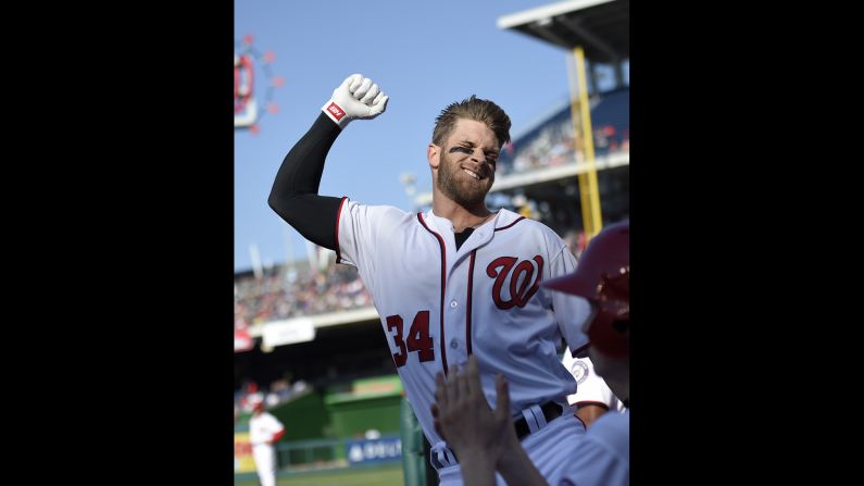 Washington Nationals' Bryce Harper pumps his fist after he hit a grand slam during the third  inning against the Atlanta Braves on Thursday, April 14, in Washington. This was Harper's 100th home run of his career.