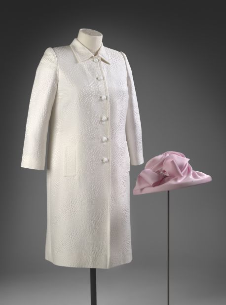 Pink silk dress with white jacquard coat designed by Stewart Parvin, and pink hat by Philip Somerville, worn to a garden party.