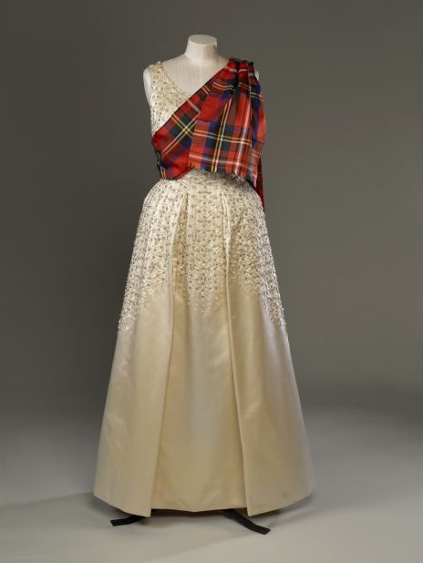 Evening dress by Norman Hartnell with a sash of Royal Stewart tartan, worn to the Gillies Ball at Balmoral Castle.