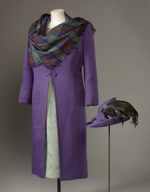 Purple silk-wool coat with a green silk-crepe and lace dress, and a shawl of purple and green Isle of Skye tartan by Sandra Murray, worn to the official opening of the Scottish Parliament on July 1, 1999. 
