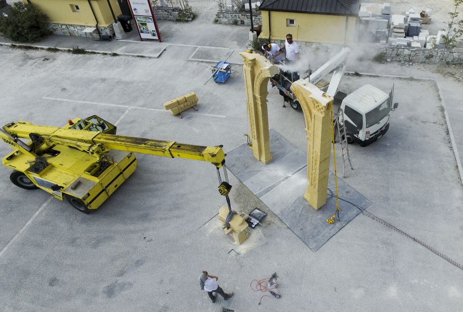 Crews carefully assemble the replica arch.