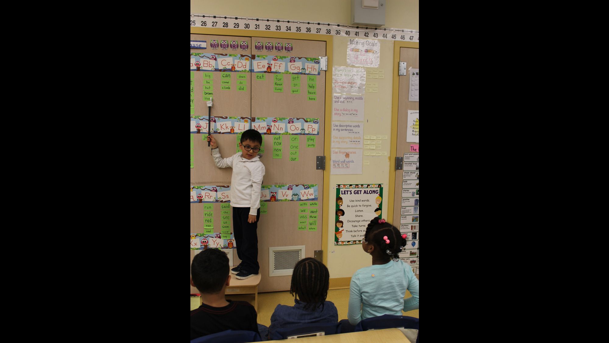 A student at P.S. 94 practices sight words with his classmates. 