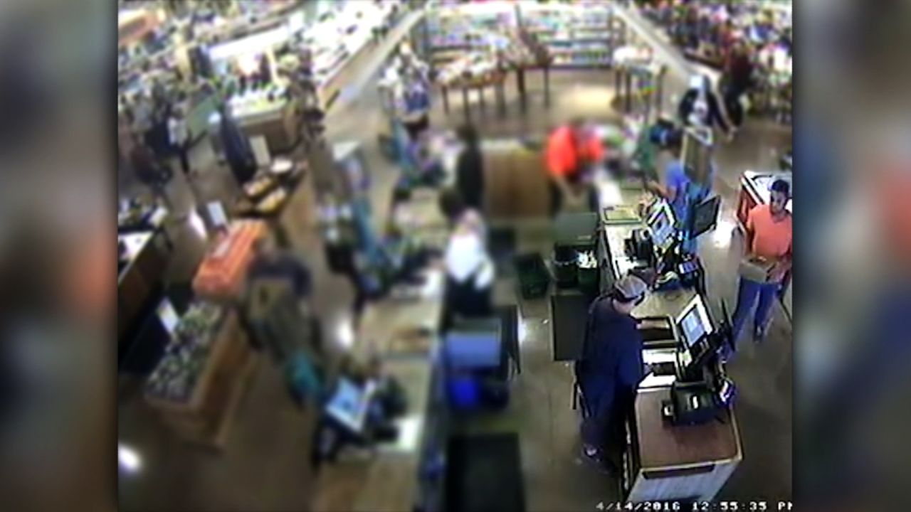 A screen grab of Whole Foods security footage, released by the company in April, showing the moment the cake was purchased. Brown is pictured on the far right.