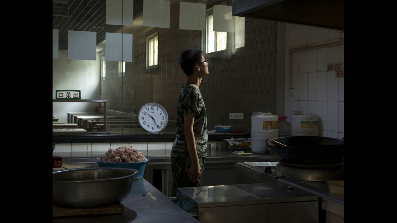 A 14-year-old internee spends time in the kitchen. He had been living at the center for two months.