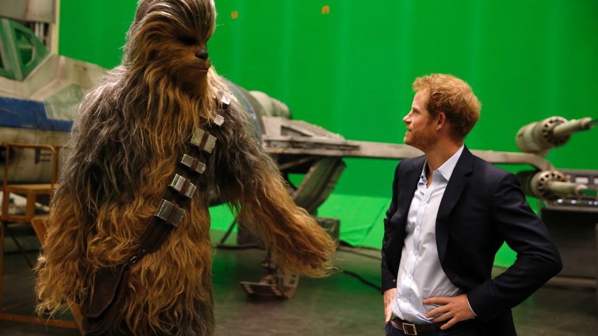 IVER HEATH, ENGLAND - APRIL 19: Prince Harry (R) meets Chewbacca during a tour of the Star Wars sets at Pinewood studios on April 19, 2016  in Iver Heath, England. Prince William and Prince Harry are touring Pinewood studios to visit the production workshops and meet the creative teams working behind the scenes on the Star Wars films. (Photo by Adrian Dennis-WPA Pool/Getty IMages)
