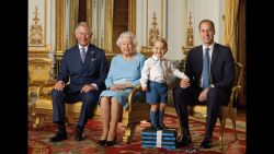 In this image released by the Royal Mail on Wednesday April 20, 2016, Britain's Prince George stands on foam blocks during a photo shoot for the Royal Mail in the summer of 2015 in the White Drawing Room at Buckingham Palace in London for a stamp sheet to mark the 90th birthday of Britain's Queen Elizabeth II.  The image features four generations of the Royal family, from left, Prince Charles, Queen Elizabeth II, Prince George and Prince William, the Duke of Cambridge. (Ranald Mackechnie/Royal Mail via AP) MANDATORY CREDIT