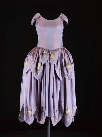 In the 1920s, Jeanne Lanvin became known for her <em>robe de style</em> with its full pannier hips, and her trademark use of intricate trimming and embroideries in light floral colors. <br /><br />In an example of successful brand marketing, the illustrator Paul Iribe sketched Jeanne and her daughter both wearing a dress in this style, and the image has been used as the logo for the house since 1927.  <br /><br />We acquired this dress recently from a vintage haute couture specialist in London to enable us to tell this story.  It offers an eye-catching contrast to the androgynous flapper style that we usually associate with the decade.