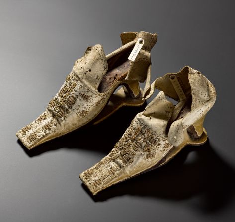 These shoes were once thought to have belonged to Mary Queen of Scots, although they have since been dated to nearly a century later.  The slap sole was initially used on men's shoes to prevent their heels sinking into the mud; women's shoemakers caught on and they were adopted as a fashion accessory in the second half of the century. <br /><br />The distinctive clacking sound they made (the sole was only attached to the ball of the foot and not the heel) was associated with wealth and sophistication. 