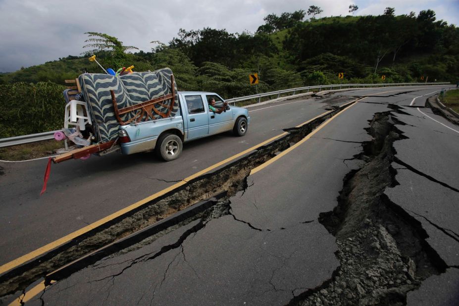 A truck moves the belongings of a family from Pedernales to Jama over a road destroyed in the quake on April 18.