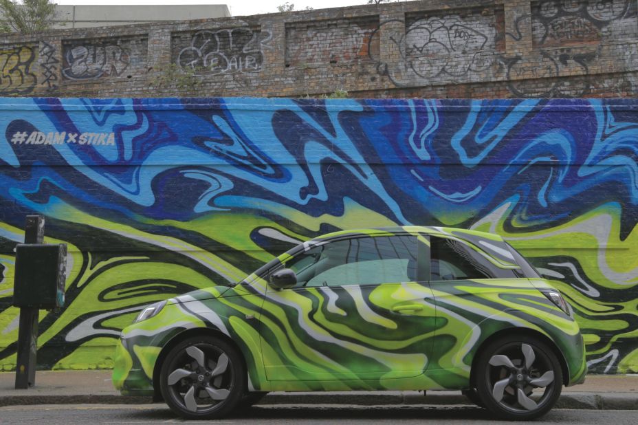 Contemporary British artist Josh Stika's street artwork, featuring a Vauxhall Adam, was on show in Shoreditch, East London, during May 2015.