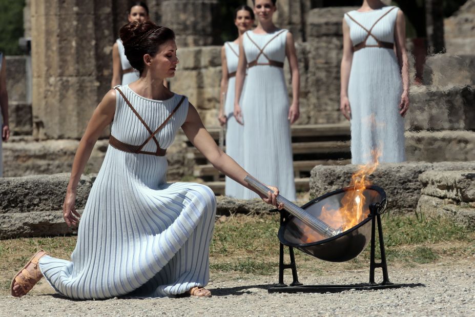 The flame is lit at the Ancient Stadium in Olympia, Greece, and initially derived from the sun's rays in a parabolic mirror. After an elaborate ceremony, it is handed over to the first torchbearer. 