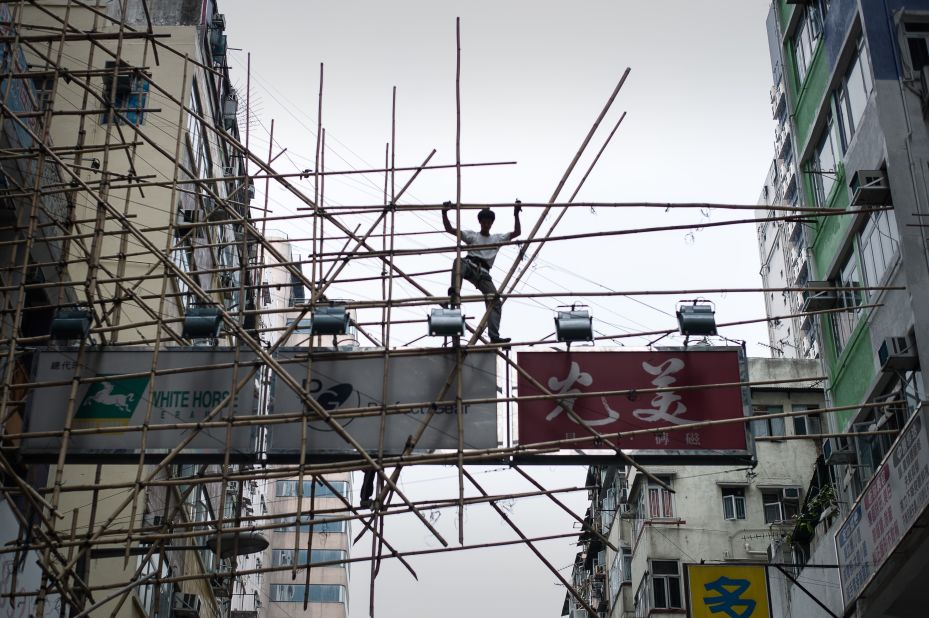 A technique known as 'riding the bamboo' involves keeping an ankle wrapped around the pole at all times -- allowing workers to keep their hands free while remaining safe.