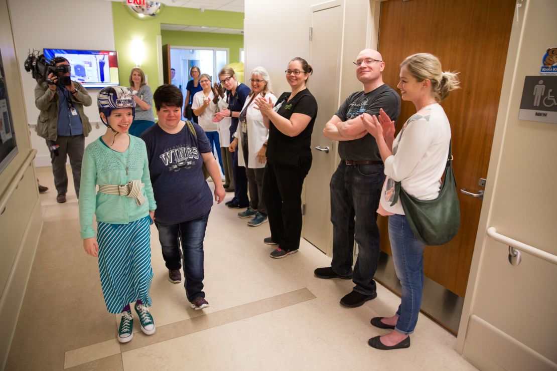 Staffers at Mary Free Bed Rehabilitation Hospital applaud as Abigail and her mother, Vickie, leave for home.