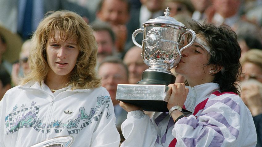 Arantxa Sanchez Vicario of Spain kissing the trophy after winning the ladies singles final of the French Open Tennis Championships held at Roland Garros, Paris, France during June 1989.  She beat Steffi Graf (left) 7-6, 3-6, 7-5.   (Photo by Bob Thomas/Getty Images).