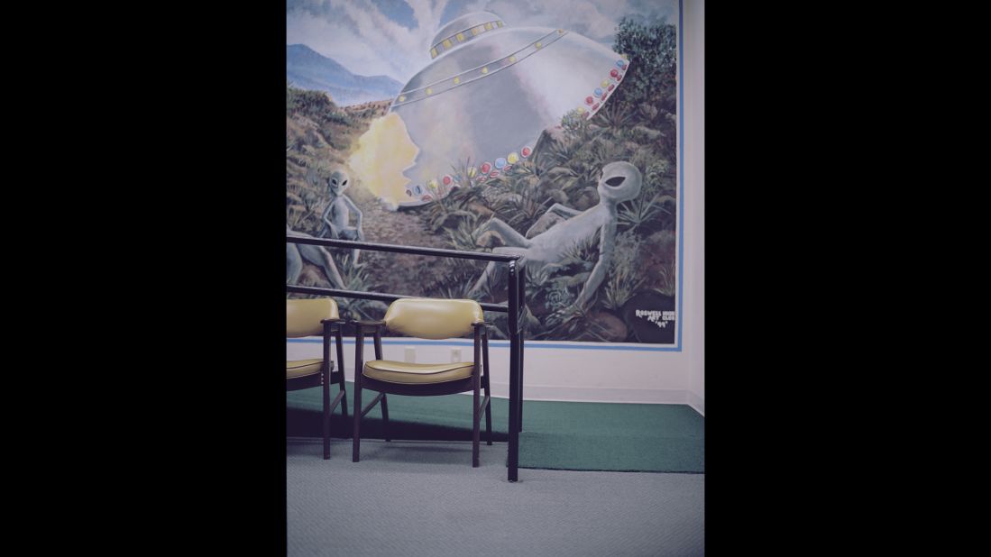 A painting shows an alien at the International UFO Museum and Research Center, which is in Roswell, New Mexico. In 1947, an officer at the Roswell Army Air Field released a statement saying, "We have in our possession a flying saucer." The next day, the military said it was just a weather balloon -- but conspiracy theories have persisted for decades.