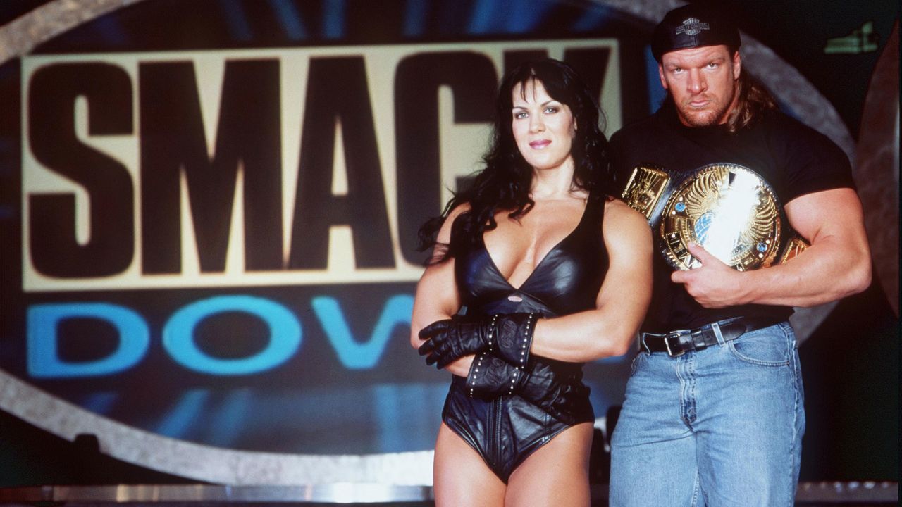 Chyna and wrestler Triple H pose for a photo in 1999.
