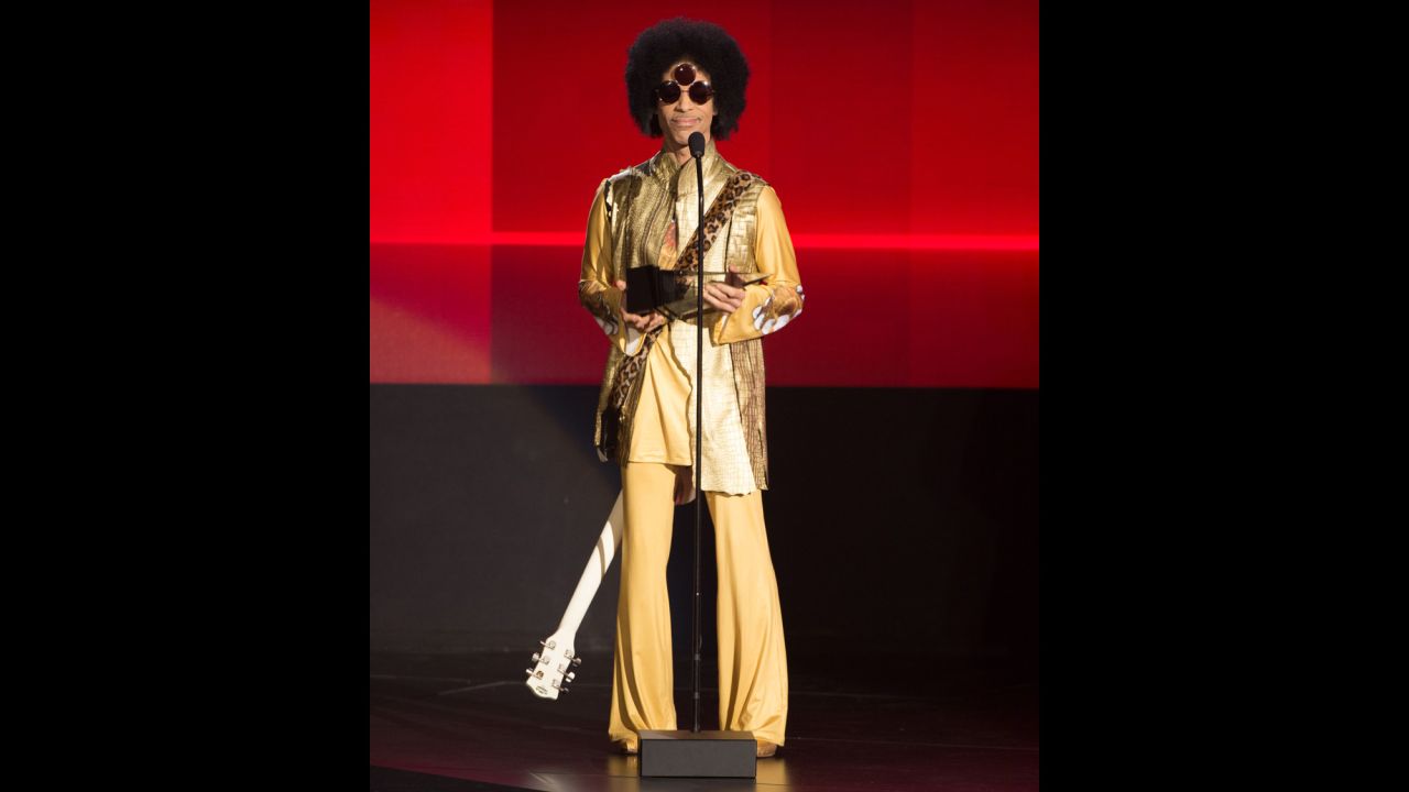 Solid gold -- Prince speaking onstage during the 2015 American Music Awards.<br />