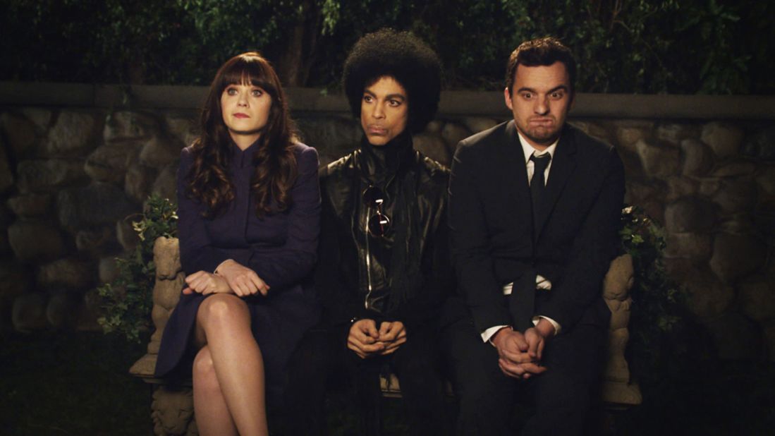 Left to right: Zooey Deschanel, Prince, and Jake Johnson in a scene from the TV show "New Girl" which aired in 2014.