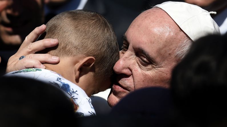 Pope Francis hugs a child at the Moria refugee camp on the Greek island of Lesbos on Saturday, April 16, 2016. Pope Francis received an emotional welcome on the island <a href="index.php?page=&url=http%3A%2F%2Fwww.cnn.com%2F2016%2F04%2F16%2Feurope%2Fpope-visits-refugees-lesbos%2F" target="_blank">during a visit showing solidarity</a> with migrants fleeing war and poverty.
