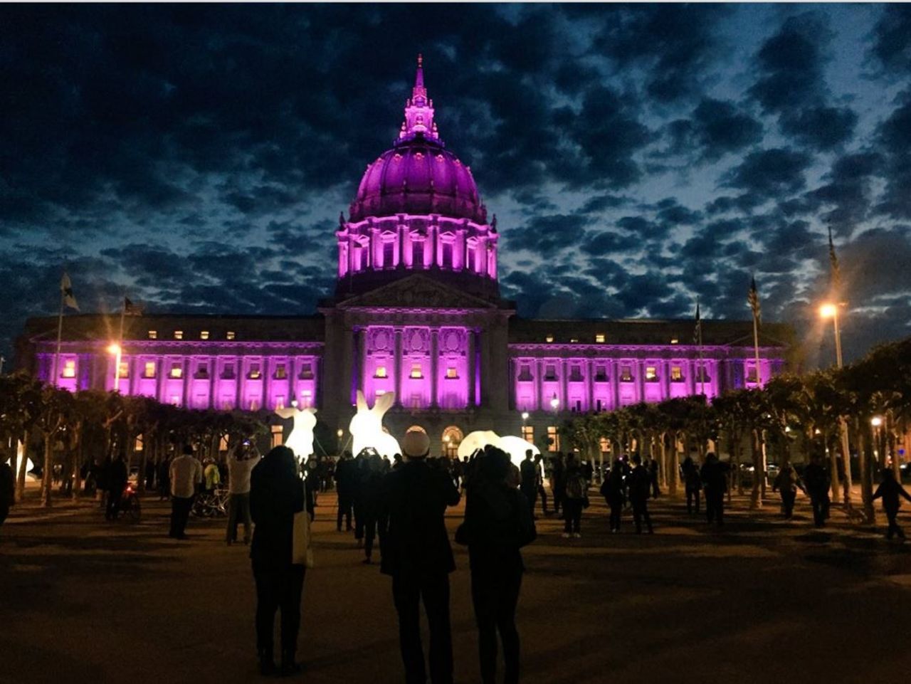 San Francisco's City Hall is seen bathed in purple light.