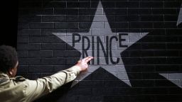 After kissing his fingers, a fan touches Prince's star on the wall of First Avenue and 7th St. Entry in Minneapolis, Minnesota, on April 21.