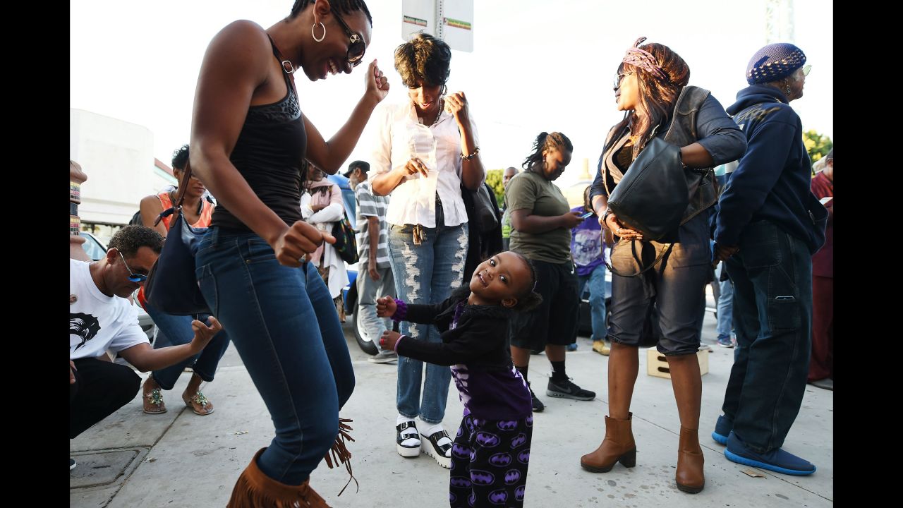 People dance in the street to the music of Prince at Leimert Park in Los Angeles on April 21.