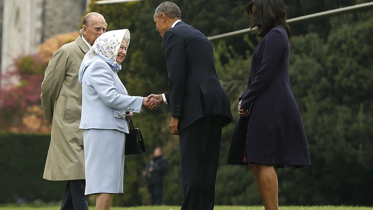 US President Barack Obama and his wife US First Lady Michelle Obama are greeted by Britain's Queen Elizabeth II and Prince Philip, Duke of Edinburgh, after landing by helicopter at Windsor Castle for a private lunch in Windsor, southern England, on April, 22, 2016.