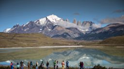 Tourists look at the Torres del Paine mountains in the Torres del Paine National Park in the Chilean Patagonia.