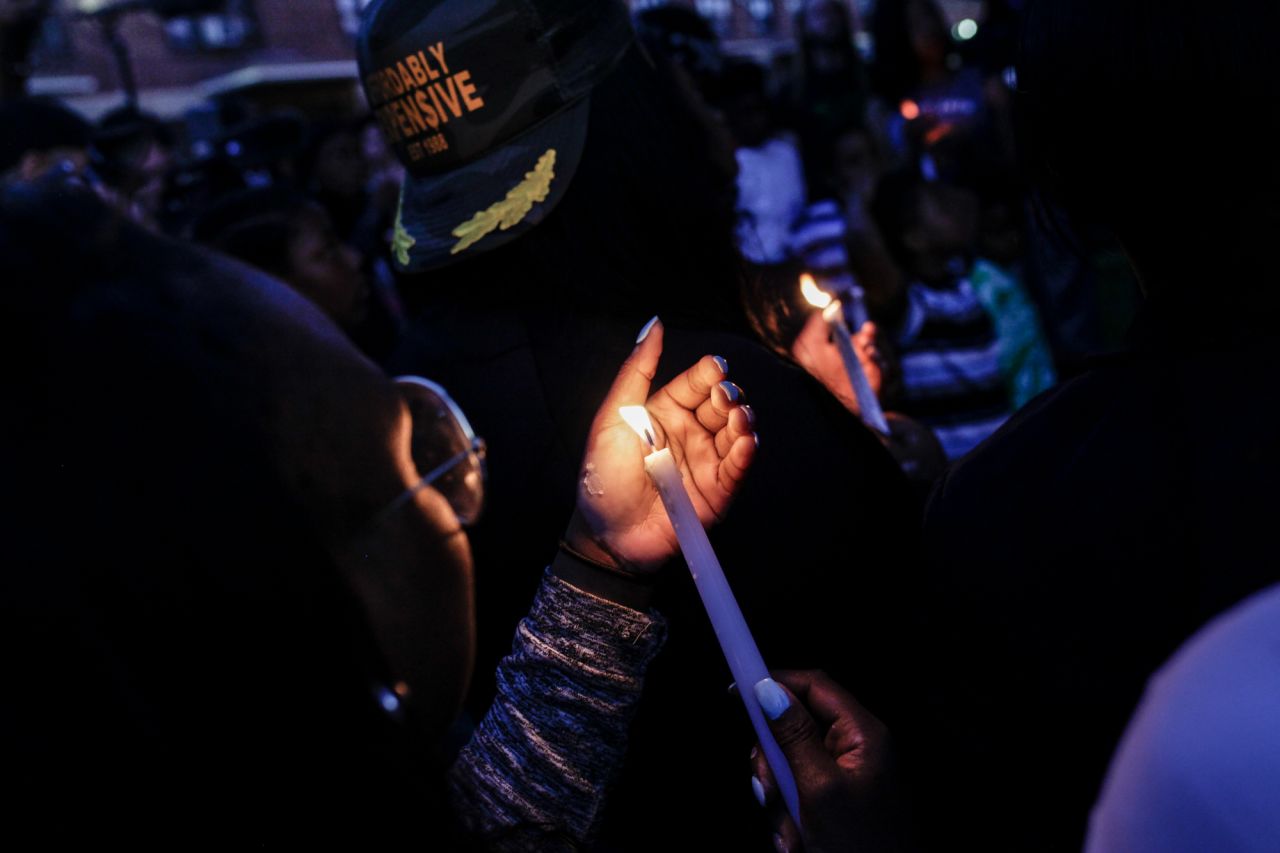 A year after protests shook Baltimore, the city is searching for a new mayor and unity. A woman lights a candle at a vigil marking the anniversary of the protests, which erupted after the death of a young black man in police custody.
