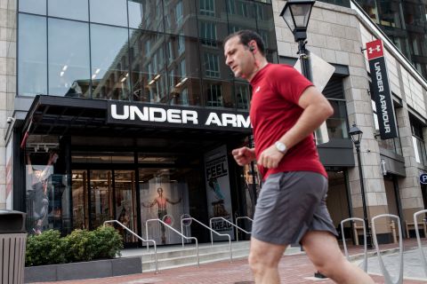 A man runs in front of Under Armour's Inner Harbor flagship store. The Baltimore-based sports apparel company is one of the city's few economic success stories, growing more than 28% in 2015.<br />