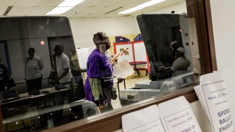 A voter submits her ballot at a polling station in West Baltimore. People are hoping the election of a new mayor will inject life in a city desperate for strong leadership. Yet some are worried that the front-runners won't bring a fresh vision.