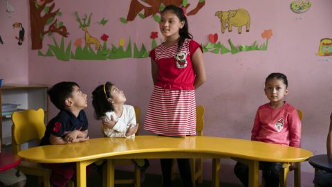 Maya recites phrases in English in her kindergarten. She will soon turn 11 and hopes to catch up to children her age.