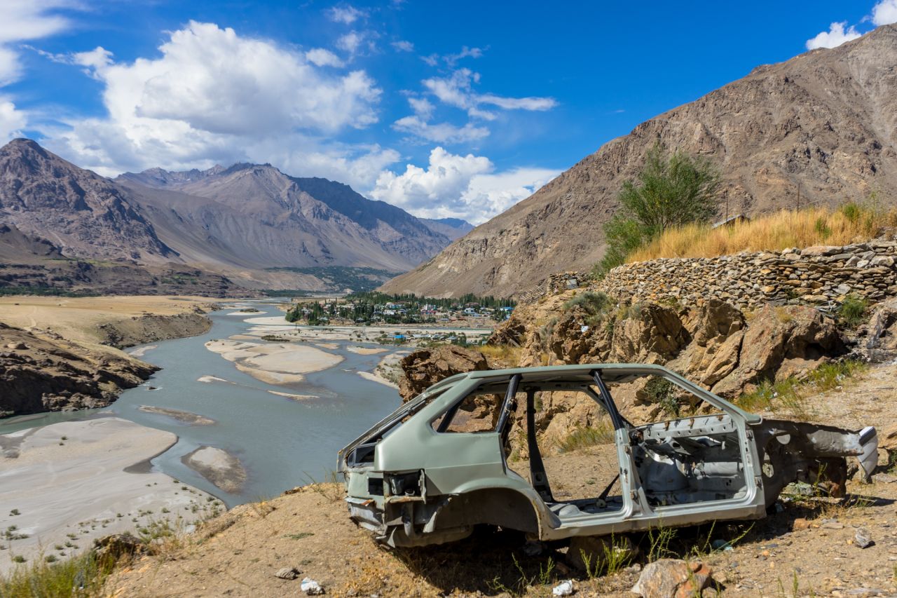 The shell of a car sits on a viewpoint of Khorog, a small town in the Gorno-Badakhshan Autonomous Region of Tajikistan.