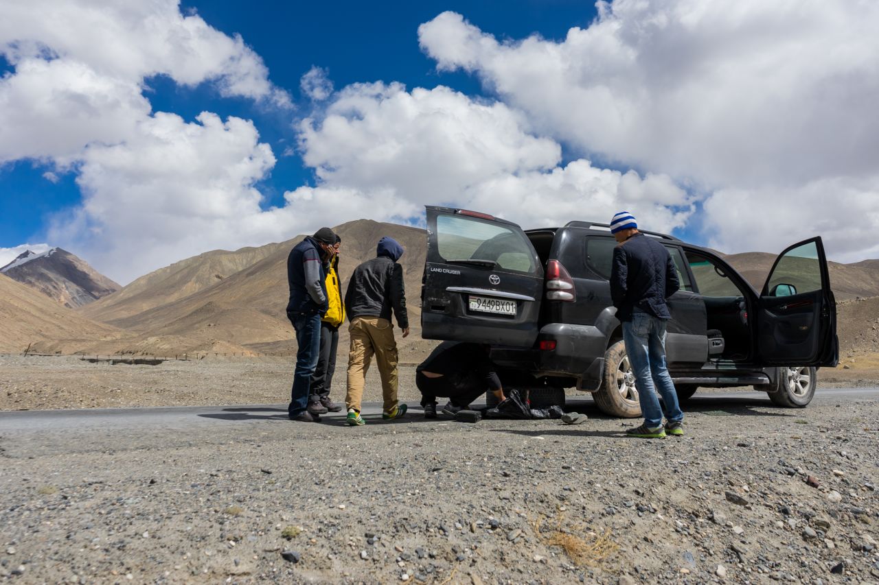 Breakdowns and flat tires are common on the Pamir Highway, but people will always stop to lend a helping hand.