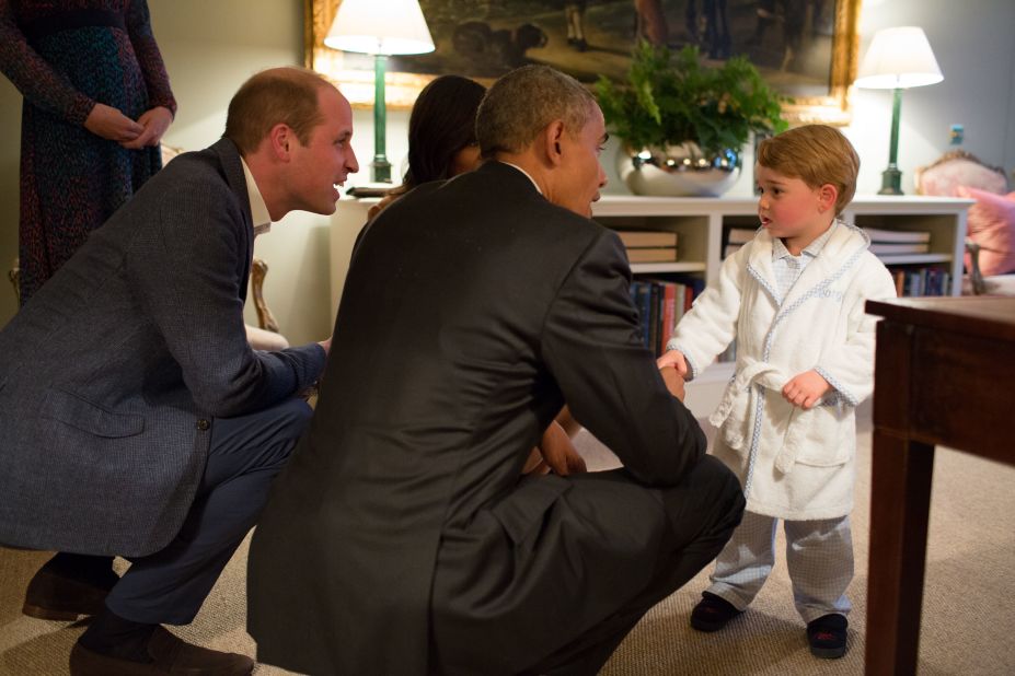 President Barack Obama, Prince William and first lady Michelle Obama talk with Prince George at Kensington Palace on April 22, 2016, in London.