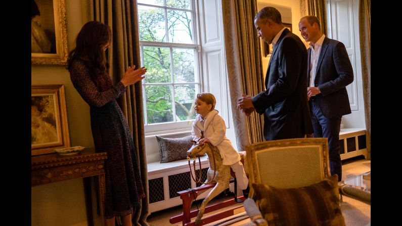 US President Barack Obama talks with Prince William as Catherine plays with Prince George in April 2016. The President and first lady Michelle Obama <a href="index.php?page=&url=http%3A%2F%2Fwww.cnn.com%2F2016%2F04%2F18%2Fpolitics%2Fgallery%2Fobamas-meet-royals%2Findex.html" target="_blank">were visiting Kensington Palace.</a>