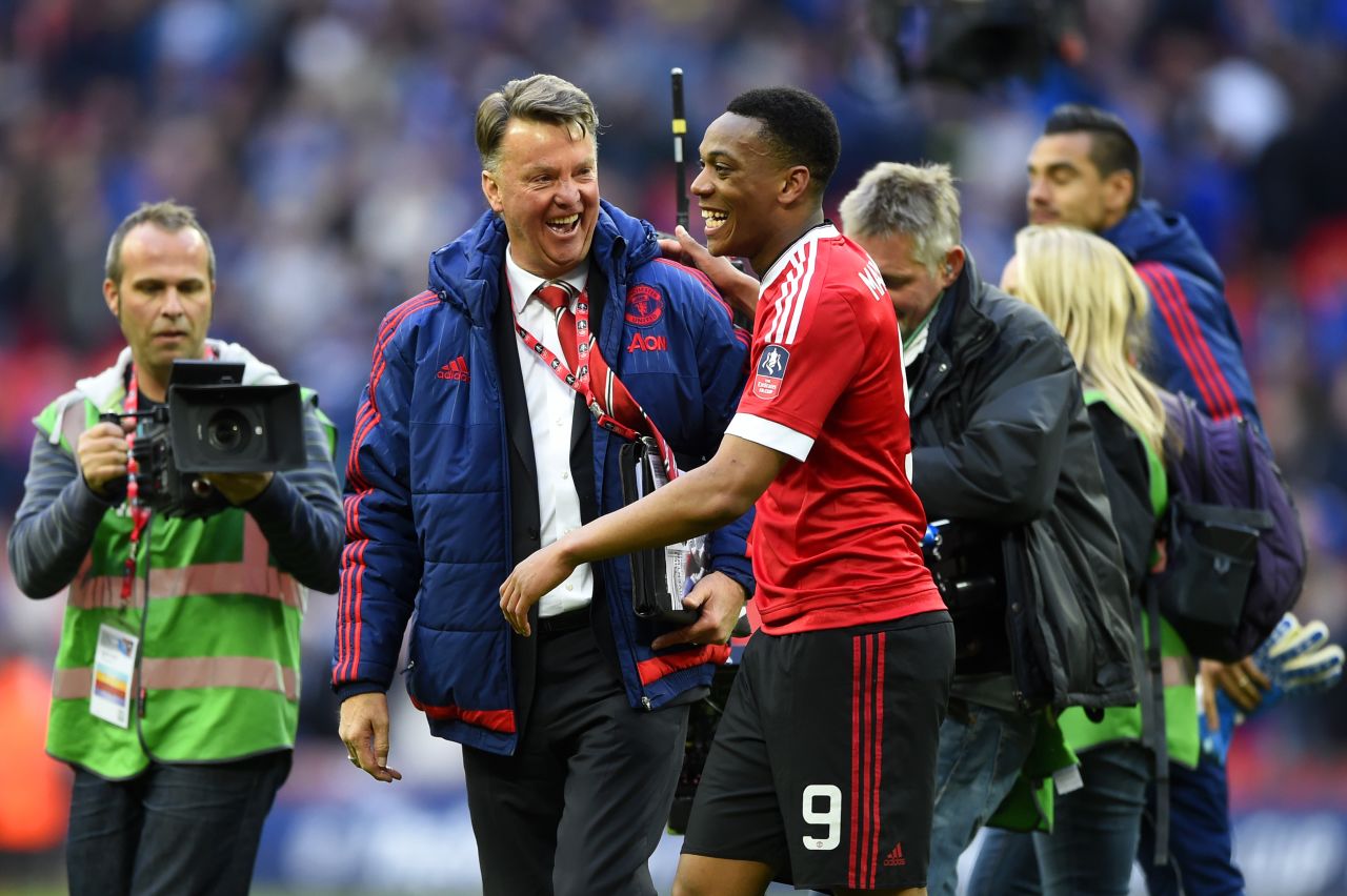 United manager, Louis van Gaal, celebrates with Martial after the final whistle.