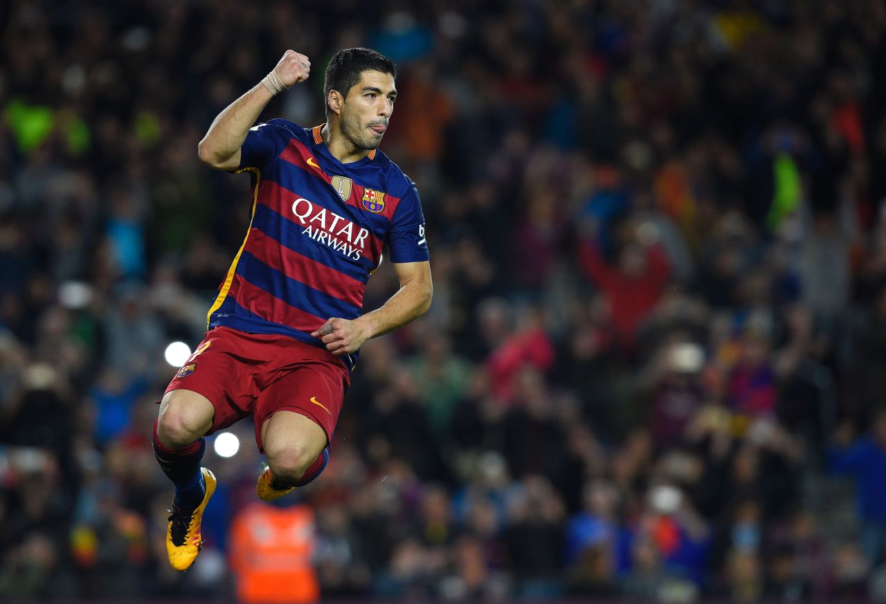 Luis Suarez celebrates scoring in Barcelona's 6-0 La Liga win over Sporting Gijon.