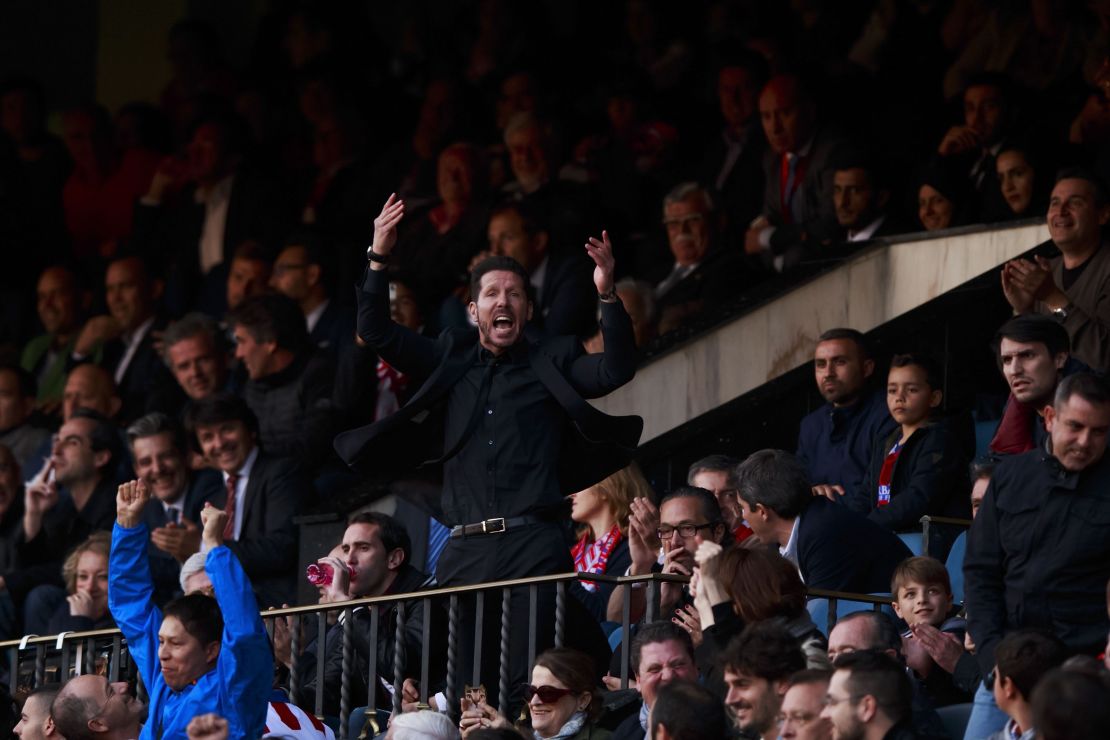Diego Simeone enocourages the crowd from the stand after being sent off during Atletico Madrid's match with Malaga.