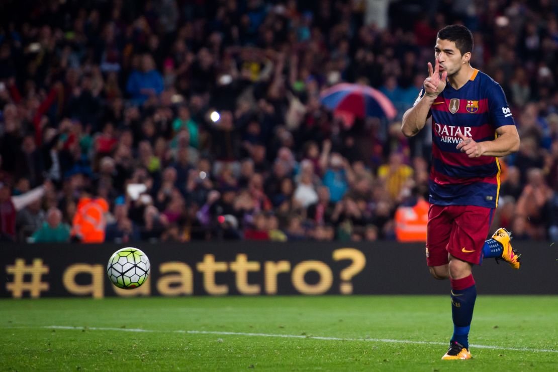 Luis Suarez celebrates after scoring Barcelona's fourth goal against Sporting Gijon.